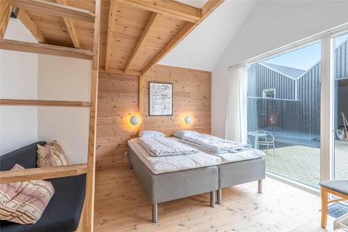 a bedroom with two bunk beds and a balcony at 711-Hvide-Sande-Slusen-11 in Hvide Sande