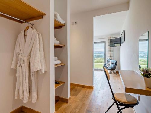 a room with a table and a chair and a desk at 2 Bed in Forfar oc-92621 in Aberlemno
