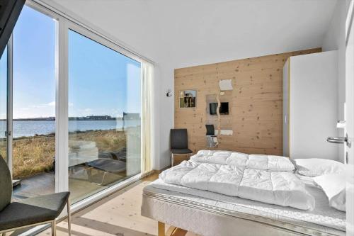 a bedroom with a bed and a large window at 749-Hvide-Sande-Slusen-49 in Hvide Sande