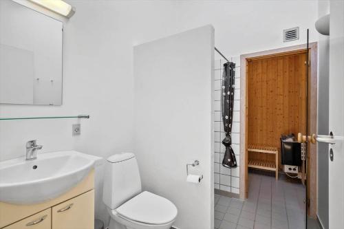 a bathroom with a white toilet and a sink at 749-Hvide-Sande-Slusen-49 in Hvide Sande