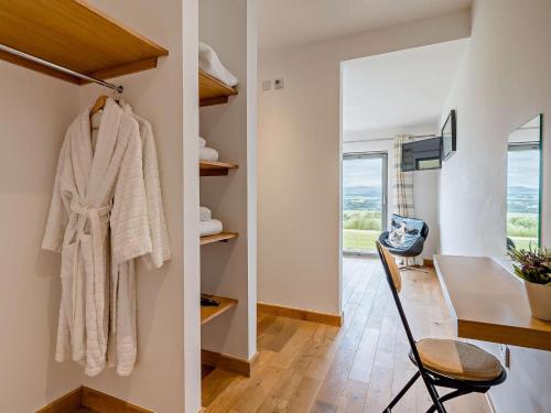 a room with a table and a coat hanging on a wall at 2 Bed in Forfar oc-92623 in Aberlemno
