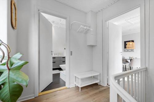 a white room with a hallway with a mirror at 890-Hvide-Sande-Bredgade-3-B-1 in Hvide Sande