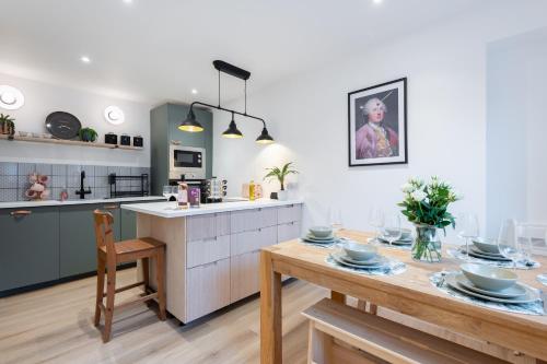 a kitchen with a wooden table and a dining room at The Pinkish House - 4 bed home in the town centre in Blairgowrie