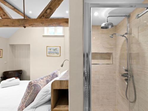 a bathroom with a shower and a bed in a room at 2 Bed in Ludlow oc-83363 in Hopton Cangeford
