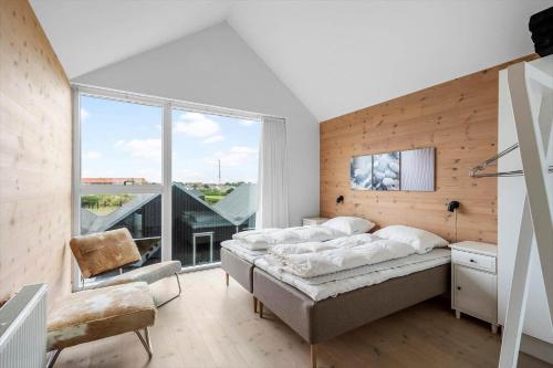 a bedroom with a bed and a large window at 733-Hvide-Sande-Slusen-33 in Hvide Sande