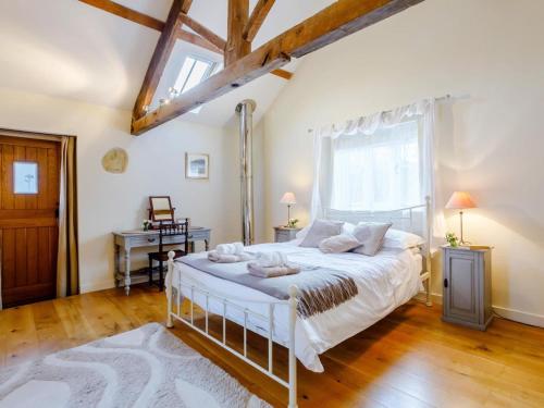 a bedroom with a bed and a large window at 2 Bed in Bridport oc-dc081 in Loders