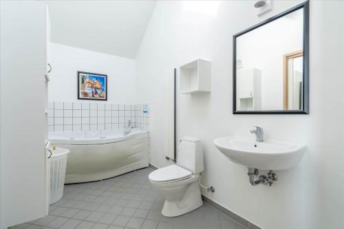 a bathroom with a toilet and a sink and a tub at 705-Hvide-Sande-Slusen-5 in Hvide Sande
