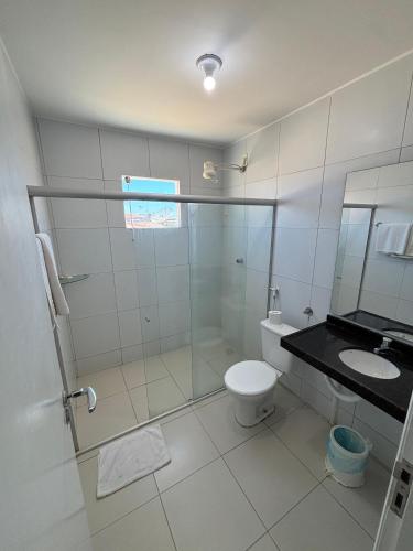 a bathroom with a shower and a toilet and a sink at Village Hotel Belém in Belém de São Francisco