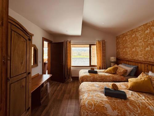 a hotel room with two beds and a window at Fisherman Lodge No 2 in Enniskillen