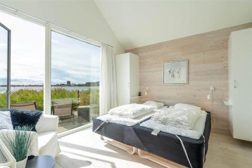 a bedroom with a bed and a large window at 706-Hvide-Sande-Slusen-6 in Hvide Sande