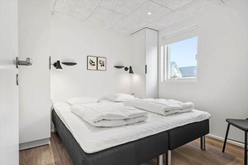 a white bedroom with a bed with white sheets at 948-Hvide-Sande-Langsand-226 in Hvide Sande