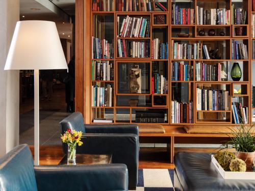 a living room with a book shelf filled with books at The Study at Yale in New Haven