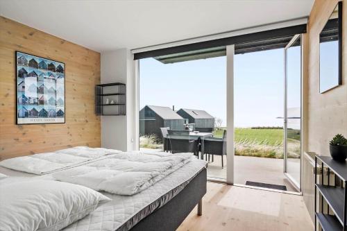 a bedroom with a large bed and a view of a table at 722-Hvide-Sande-Slusen-22 in Hvide Sande