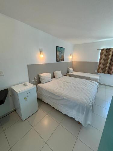 a bedroom with a large bed in a room at Village Hotel Belém in Belém de São Francisco