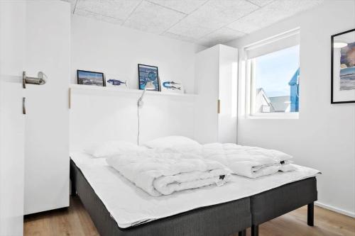 a white bedroom with a bed with white sheets at 946-Hvide-Sande-Langsand-224 in Hvide Sande