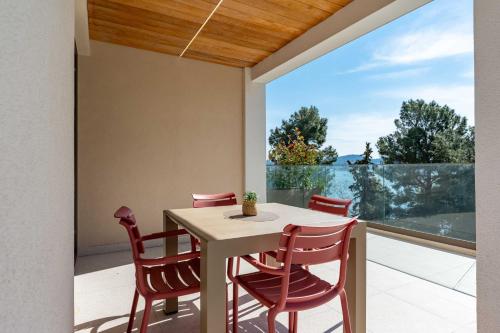 a dining room with a table and chairs on a balcony at SeaLine Residence in Bar