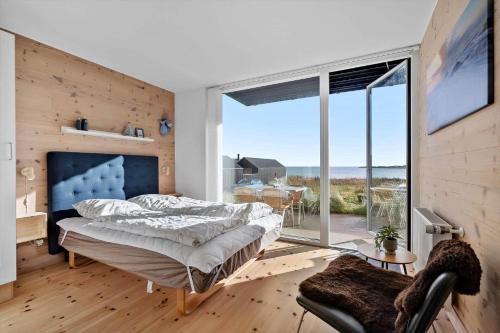 a bedroom with a bed and a large window at 7716-Hvide-Sande-Slusen-16 in Hvide Sande