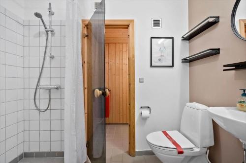 a bathroom with a shower and a toilet and a sink at 7716-Hvide-Sande-Slusen-16 in Hvide Sande