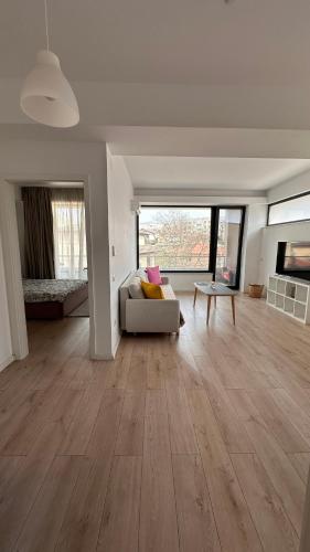 a living room with a couch and a table at Warm apartament 3 in Bucharest