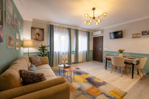 a living room with a couch and a dining room at Smart Apartments Central in Sighişoara