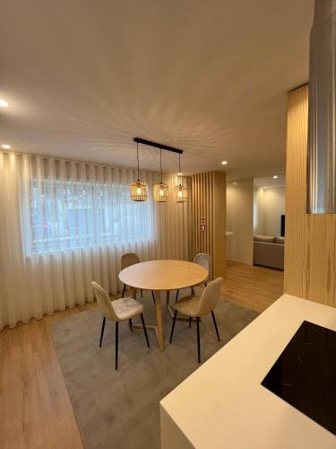 a dining room with a table and chairs at Brittos Home Lovely Stay - Villa Family in Vila Nova de Famalicão