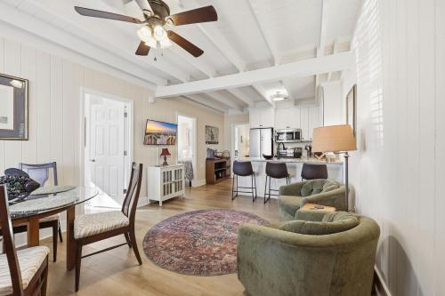 a living room with a ceiling fan and a dining room at Sunny Beach Bungalow Pet Friendly Near Beach in Myrtle Beach