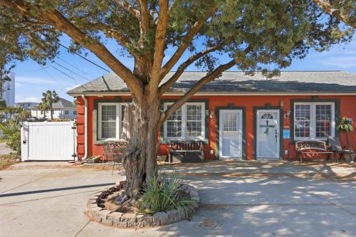 a orange house with a tree in front of it at Sunny Beach Bungalow Pet Friendly Near Beach in Myrtle Beach