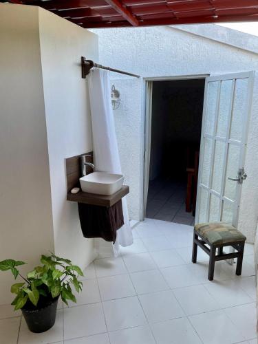 a bathroom with a sink and a shower and a toilet at Caribo Cozumel in Cozumel