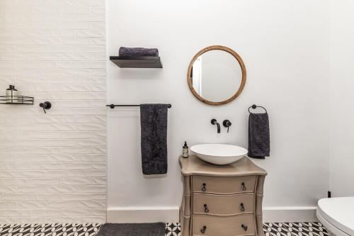 a bathroom with a sink and a mirror at Millstream manor guest house in Robertson