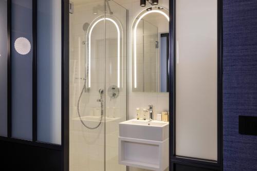 a bathroom with a sink and a shower at Best Western Plus Bretagne Montparnasse in Paris