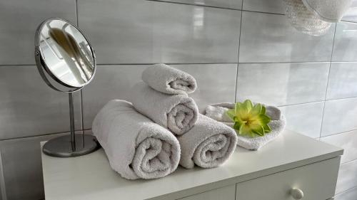 a pile of towels sitting on a counter in a bathroom at KŐNIG APARTMAN III. in Hévíz