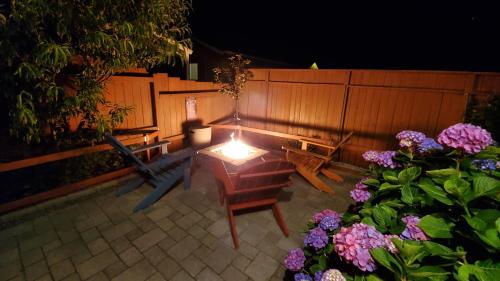 a patio with a table and chairs and flowers at Sunkissed 3BR Oceanview, Dog-Friendly Beach Home in Pacific Beach
