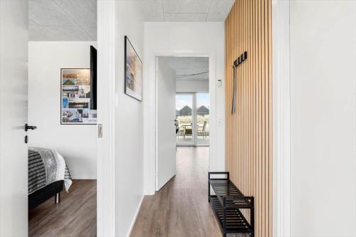 a hallway of a house with a bedroom and a bed at 9928-Hvide-Sande-Langsand-86 in Hvide Sande