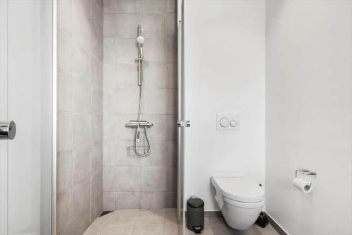 a bathroom with a shower with a toilet at 9928-Hvide-Sande-Langsand-86 in Hvide Sande