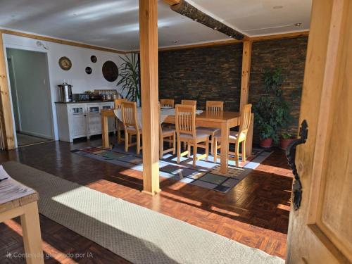 a kitchen and dining room with a table and chairs at Akainij in Puerto Williams