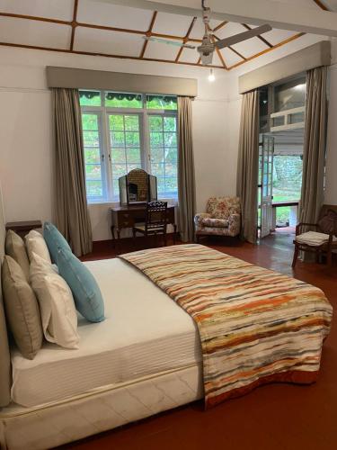 a bedroom with a large bed in a room at Malwatte Bungalows in Hali Ela