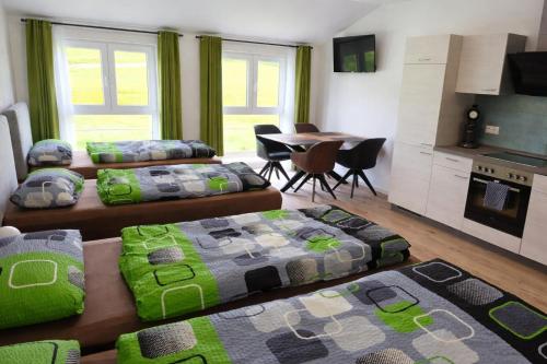 a living room with three beds and a table at Speedys Bed & Breakfast in Reimerath