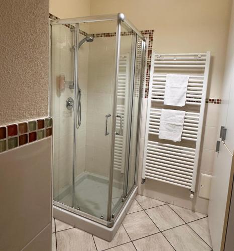 a shower in a bathroom with a glass shower stall at Made in Langhe Apartment in La Morra