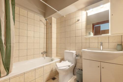 a bathroom with a sink and a toilet and a bath tub at LuckyWoodyApartment in (( Kermetés ))
