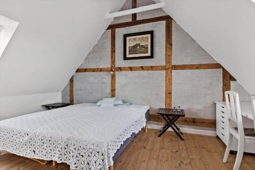 a bedroom with a white bed in a attic at 4221-Stege-Langgade-21 in Stege