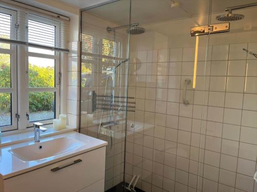 a bathroom with a sink and a glass shower at 6306-Stege-Hjelmvej-24 in Stege