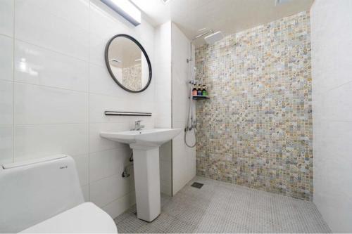 a bathroom with a sink and a mirror at CENTRO HOTEL - 안양iT단지, 군포제일공단 in Anyang