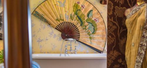 a bathroom with a painting of a fan on the wall at 16th Century Manor House in Richborough