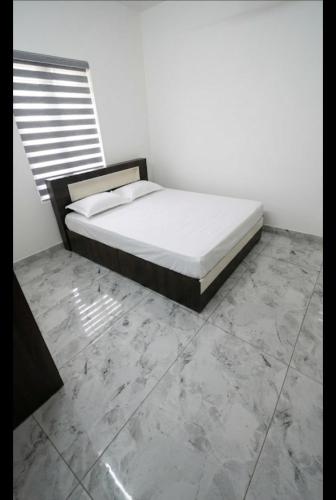 a bed in a room with a concrete floor at Lazars homestay in Fort Kochi
