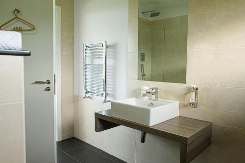 a bathroom with a white sink and a mirror at Jog Lodge 22 By Together Travel - 3 Bed Sea-View in Wick