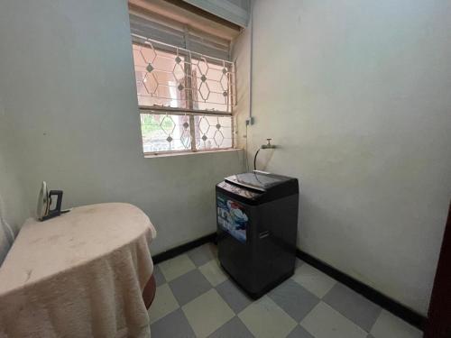 a small room with a table and a window at Angel's place in Kabale