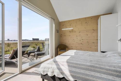 a bedroom with a bed and a large window at 740-Hvide-Sande-Slusen-40 in Hvide Sande