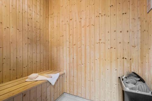 a wooden sauna with a towel and a trash can at 740-Hvide-Sande-Slusen-40 in Hvide Sande