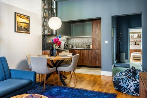 a kitchen and living room with a table and chairs at The Nest in Ruse