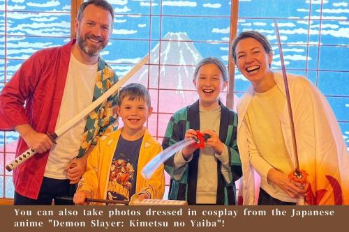 a picture of a family posing for a picture at Japanese Style Hotel WAKUWAKU-BASE Nakasendo Yabuharajuku